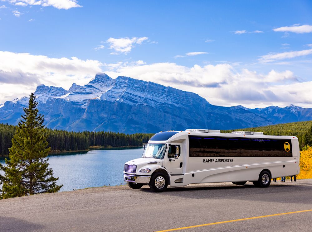 A Banff Airport Shuttle driving through Banff National Park