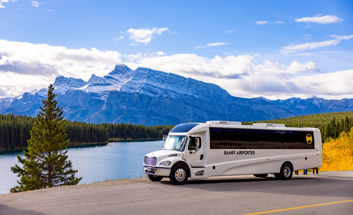 A Banff Airport Shuttle driving through Banff National Park