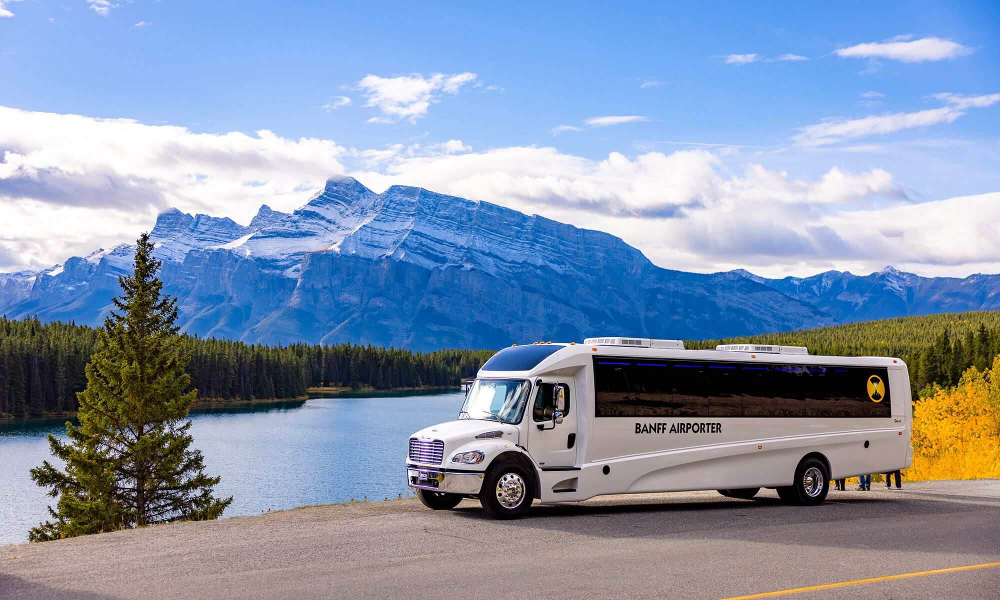 A Banff Airport Shuttle driving through Banff National Park