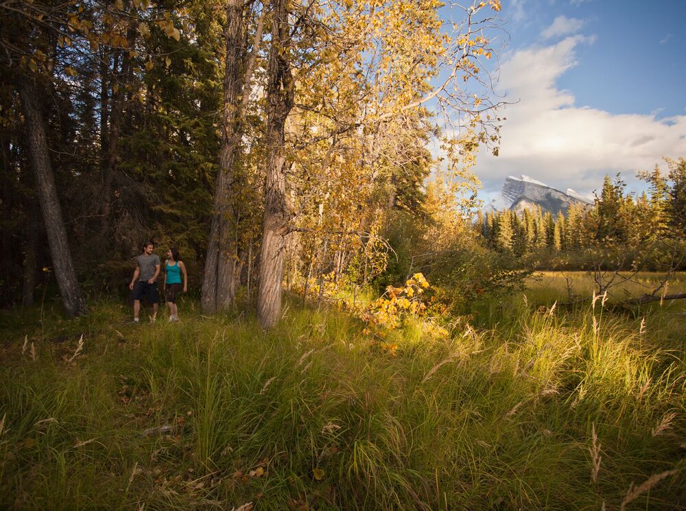 A couple walking in Banff National Park, a popular thing to do in Banff in September