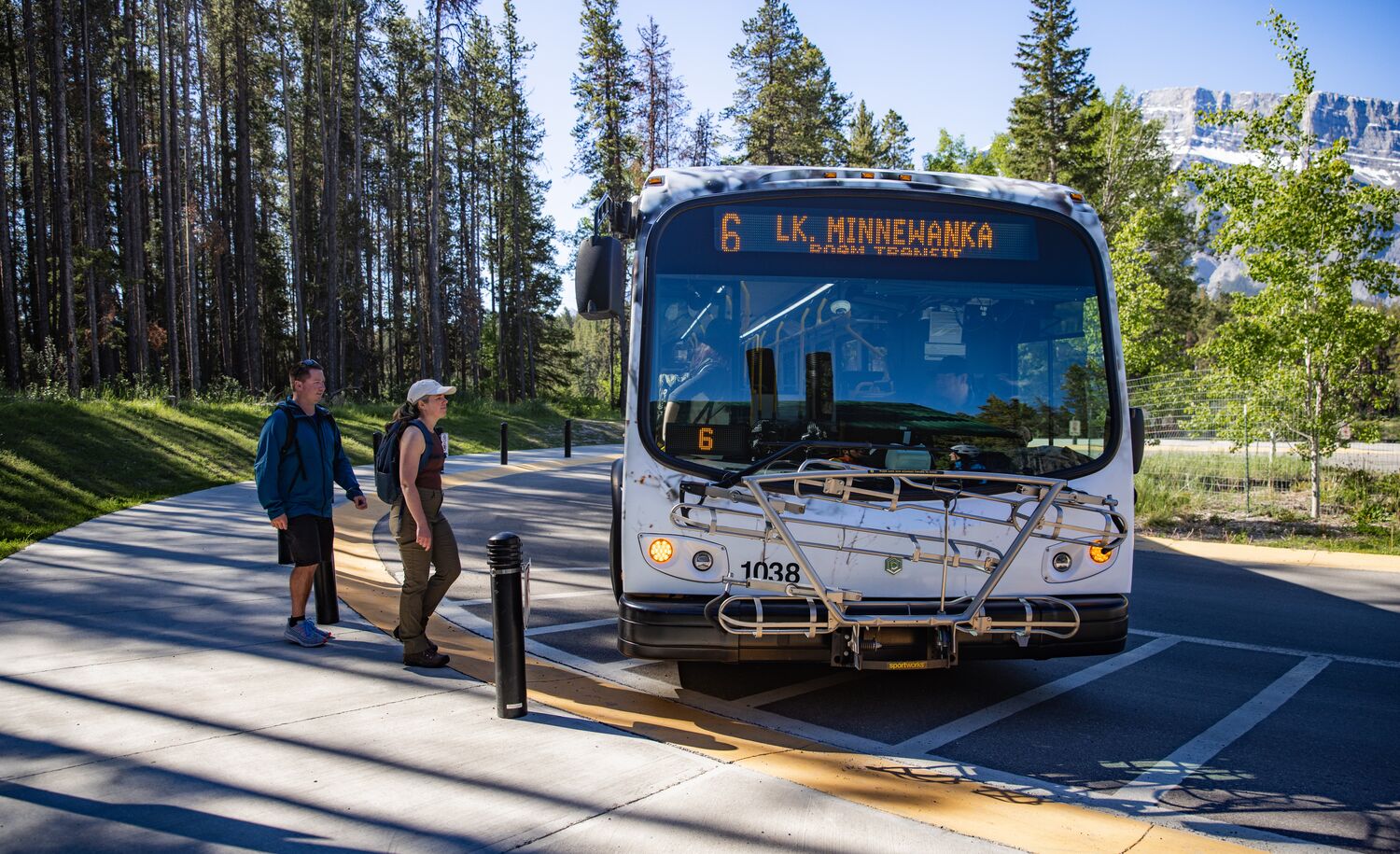 Two people getting on a Roam Transit bus in Banff National Park