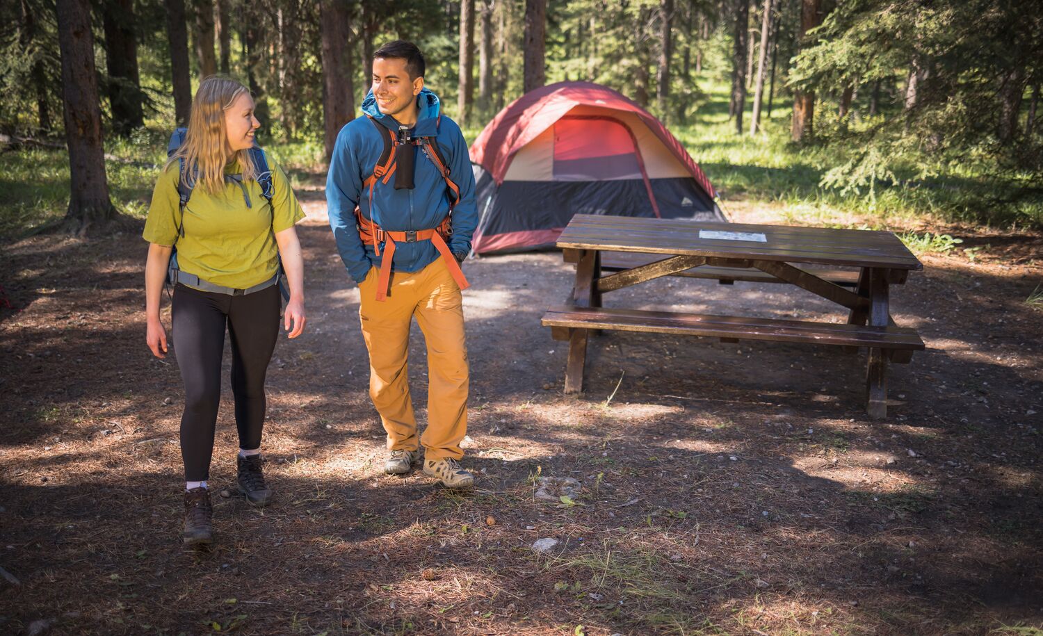 Two people walking away from their campsite in Banff National Park