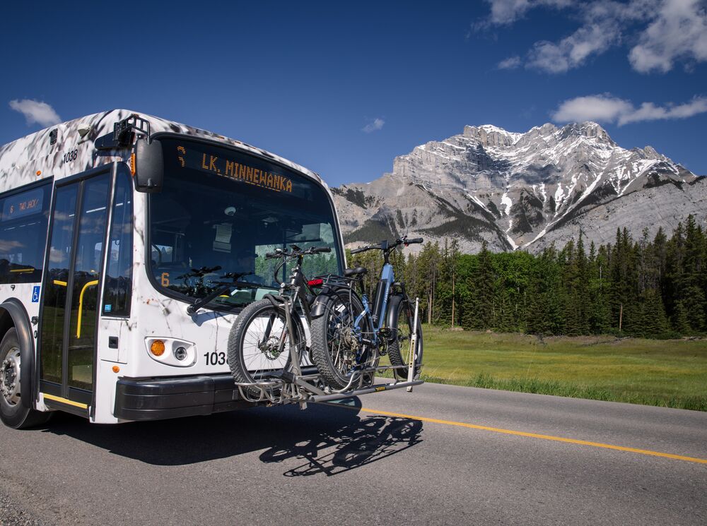 Two bikes on a front rack on their way to Lake Minnewanka for mountain biking in Banff National Park.
