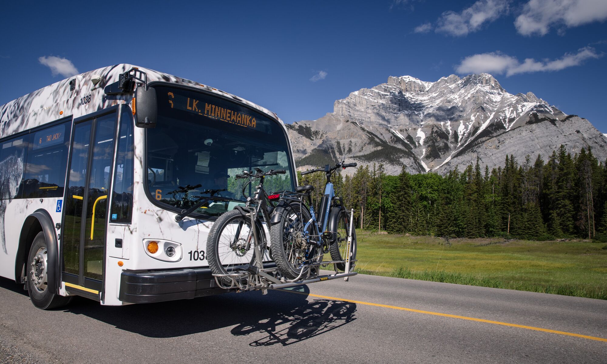 Two bikes on a front rack on their way to Lake Minnewanka for mountain biking in Banff National Park.