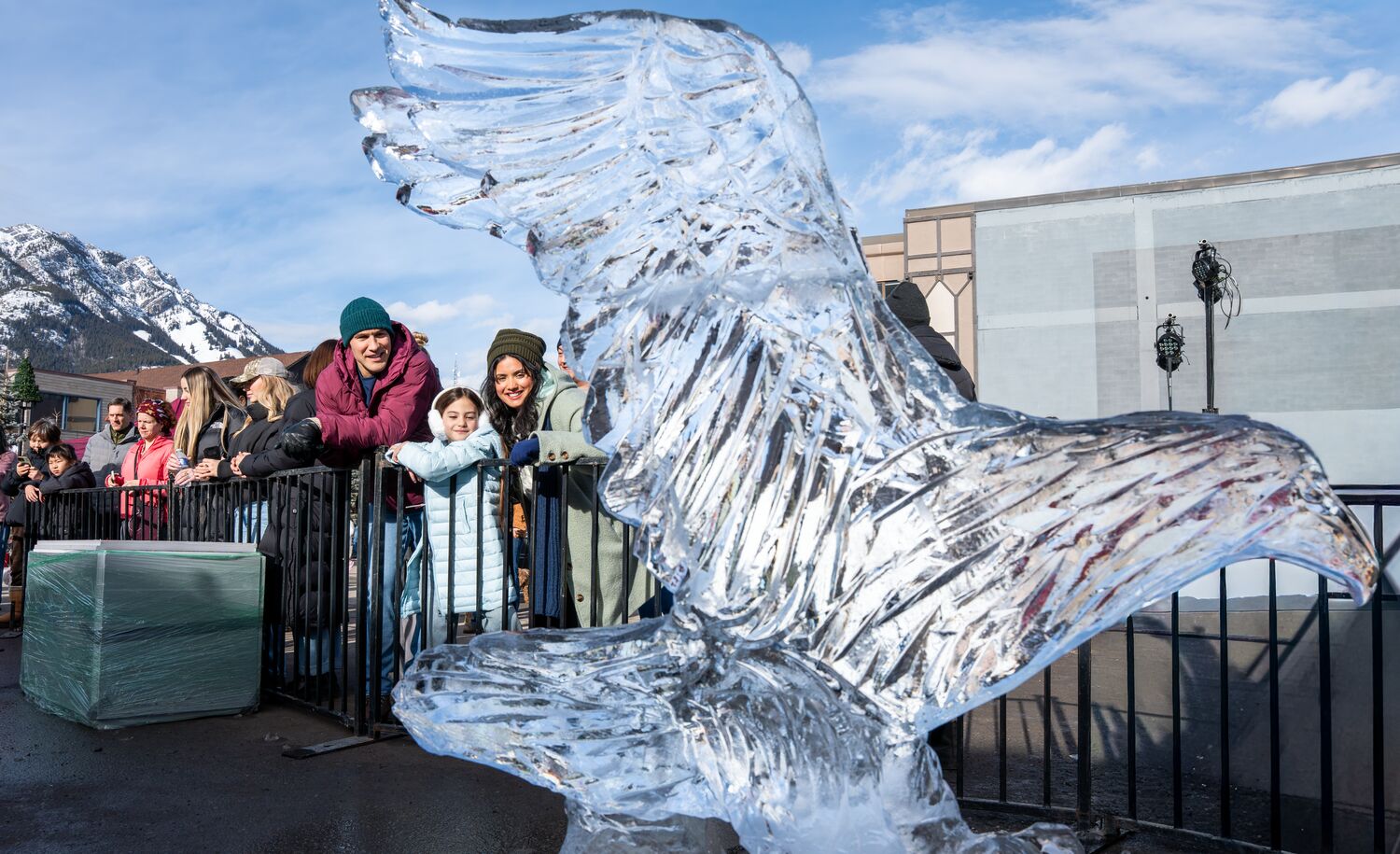 A family looking at an ice sculpture at art of ice during the SnowDays festival in Banff National Park