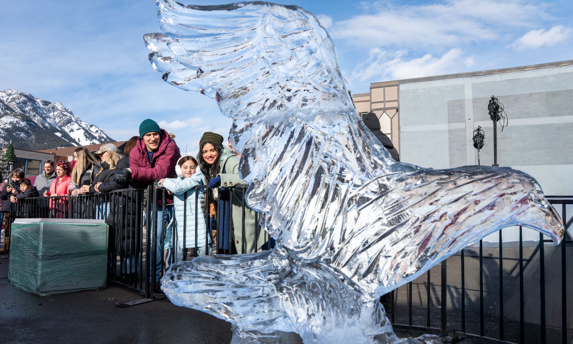 A family looking at an ice sculpture at art of ice during the SnowDays festival in Banff National Park