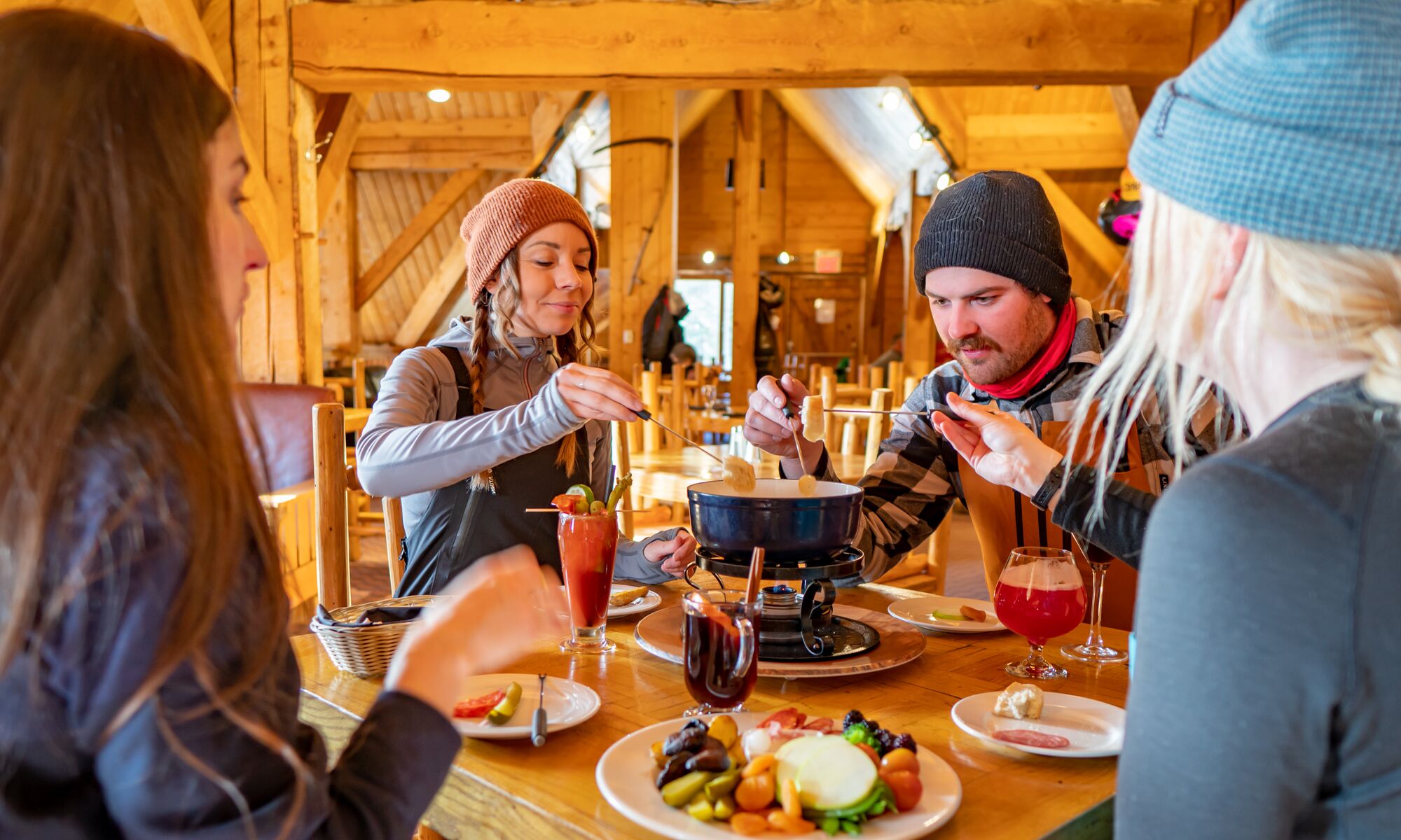 A group of friends eating fondue at the Lake Louise Ski resort in Banff National Park