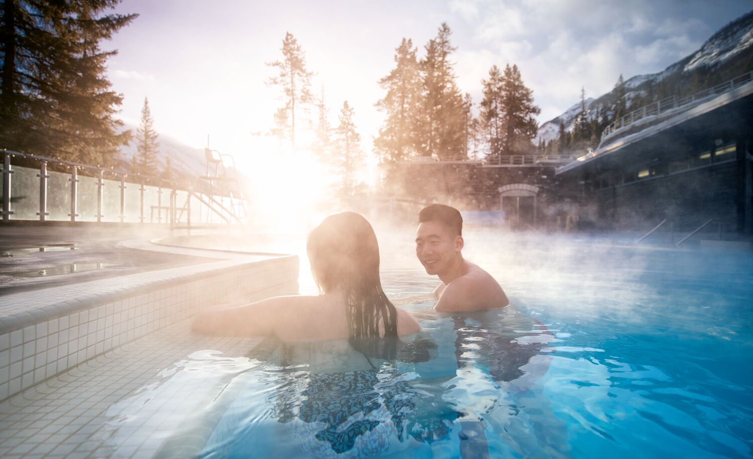 A couple inside the Banff Upper Hot Springs in the winter.