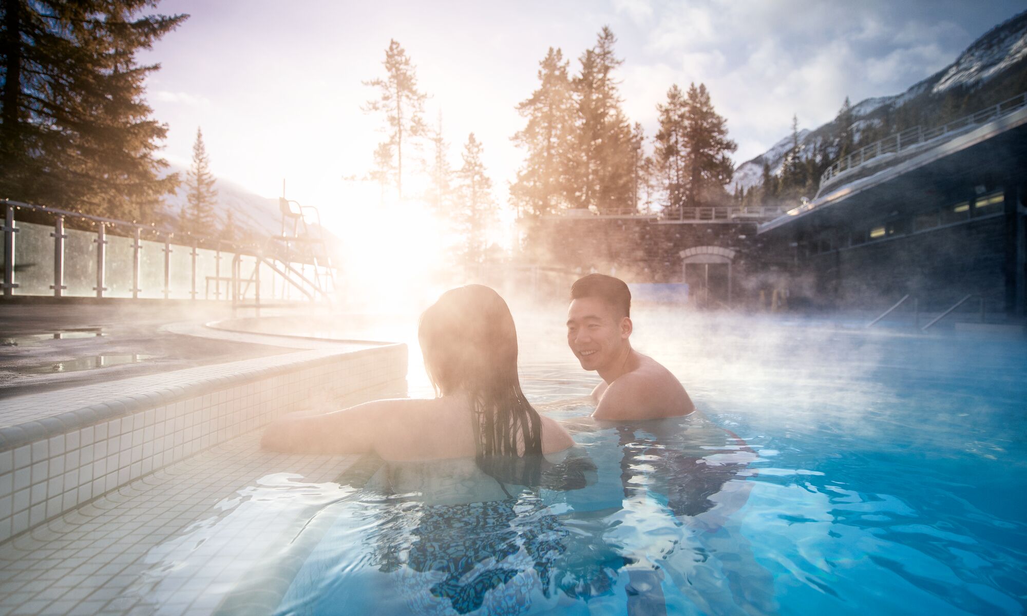 A couple inside the Banff Upper Hot Springs in the winter.