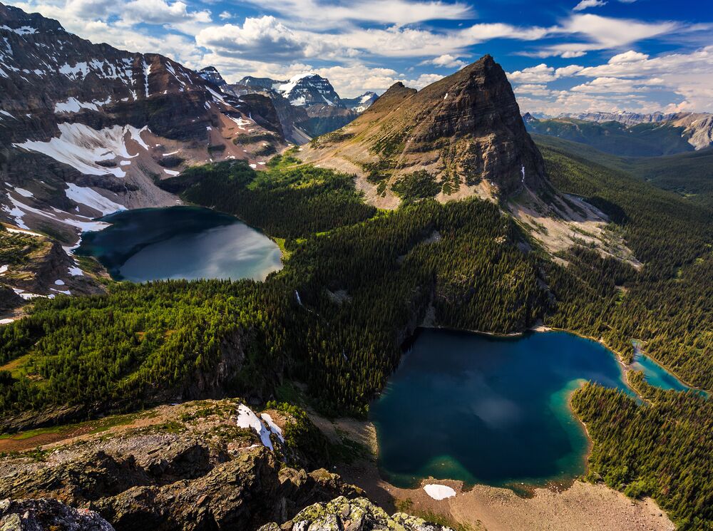 A summit-top view of two lakes and Pharaoh Peak in the Egypt Lake area in Banff National Park, one of the places you can mountain bike and then hike in Banff National Park.