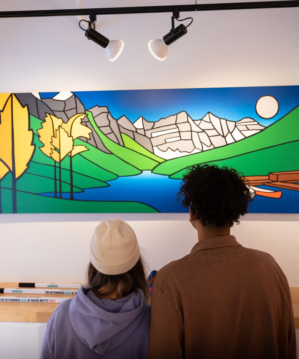 Two people taking in the artwork at Carter Ryan Gallery in Banff town.