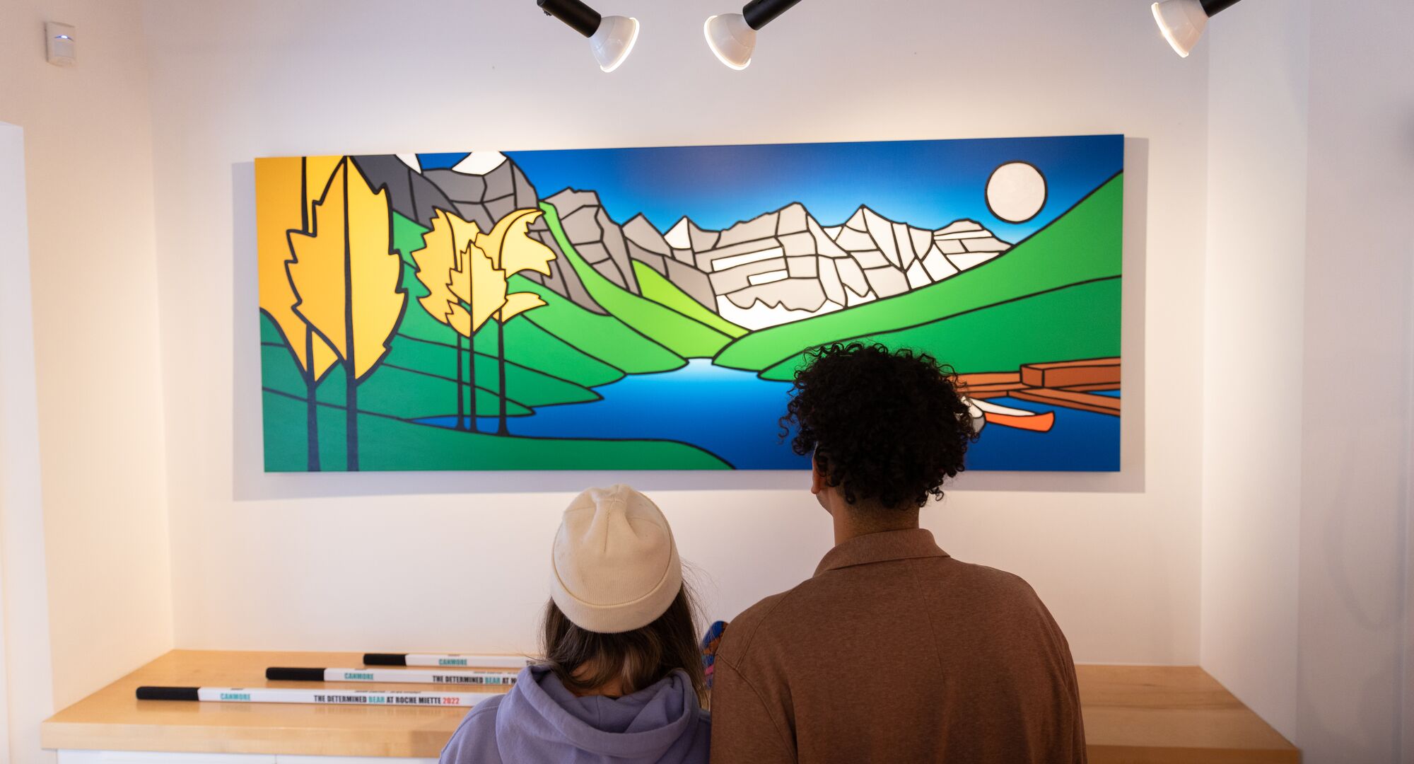 Two people taking in the artwork at Carter Ryan Gallery in Banff town.