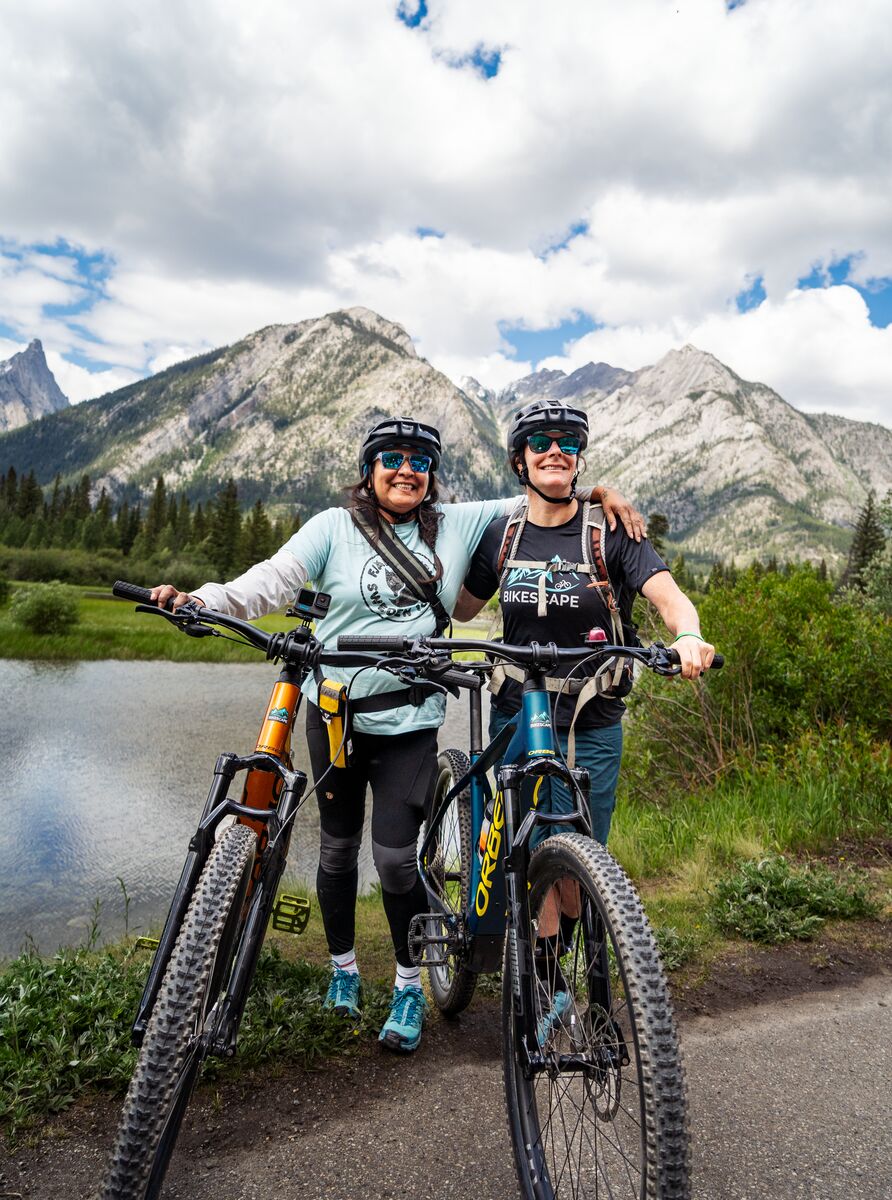 Two leaders of an indigenous biking tour pose for a photo in Banff National Park on the Sundance Trail towards Sundance Canyon.