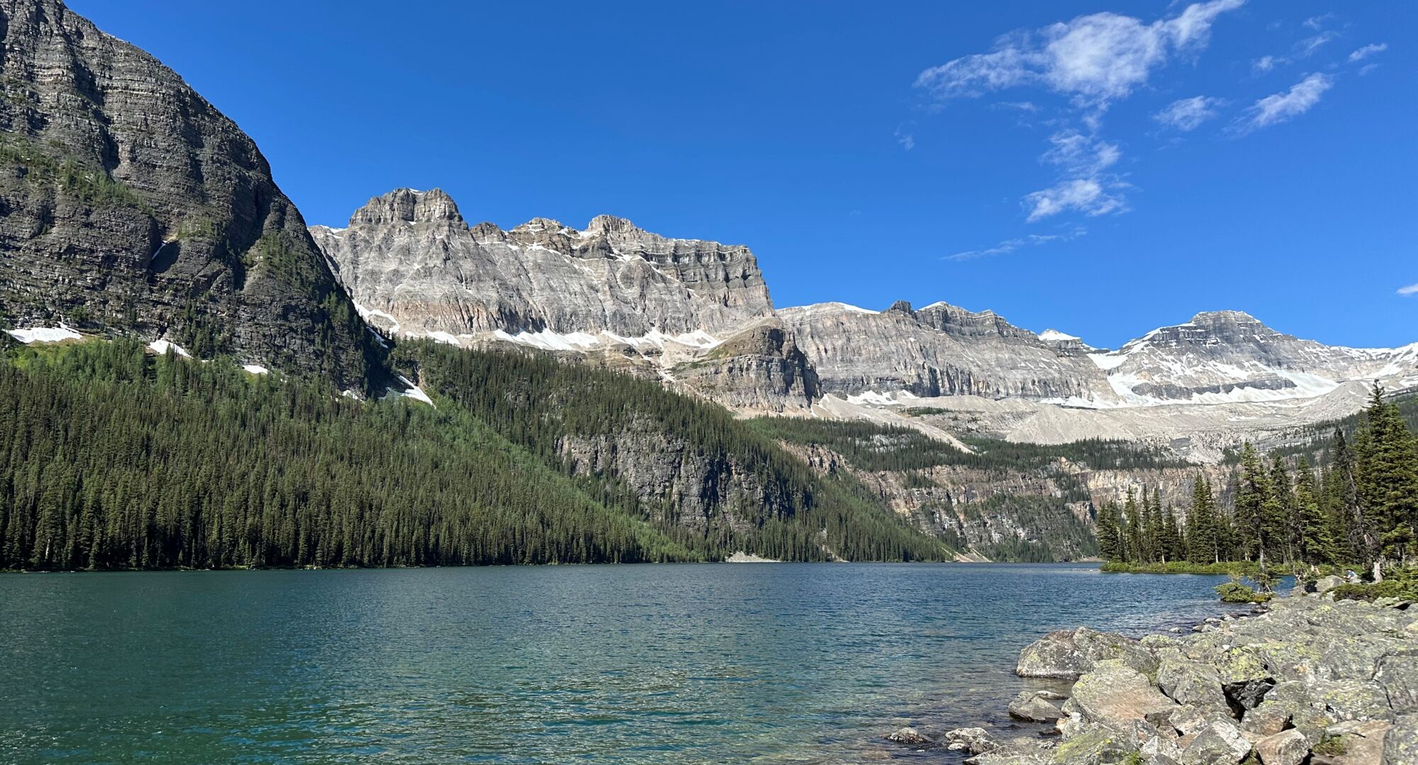 A view of Boom Lake on a blue sky day in Banff National Park in the summer.