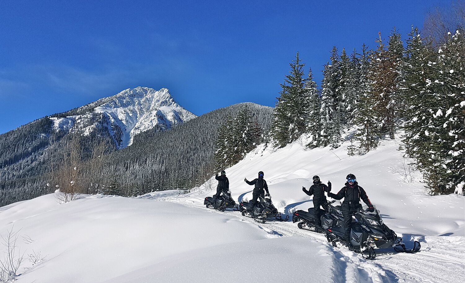 A group of people on a guided snowmobiling tour