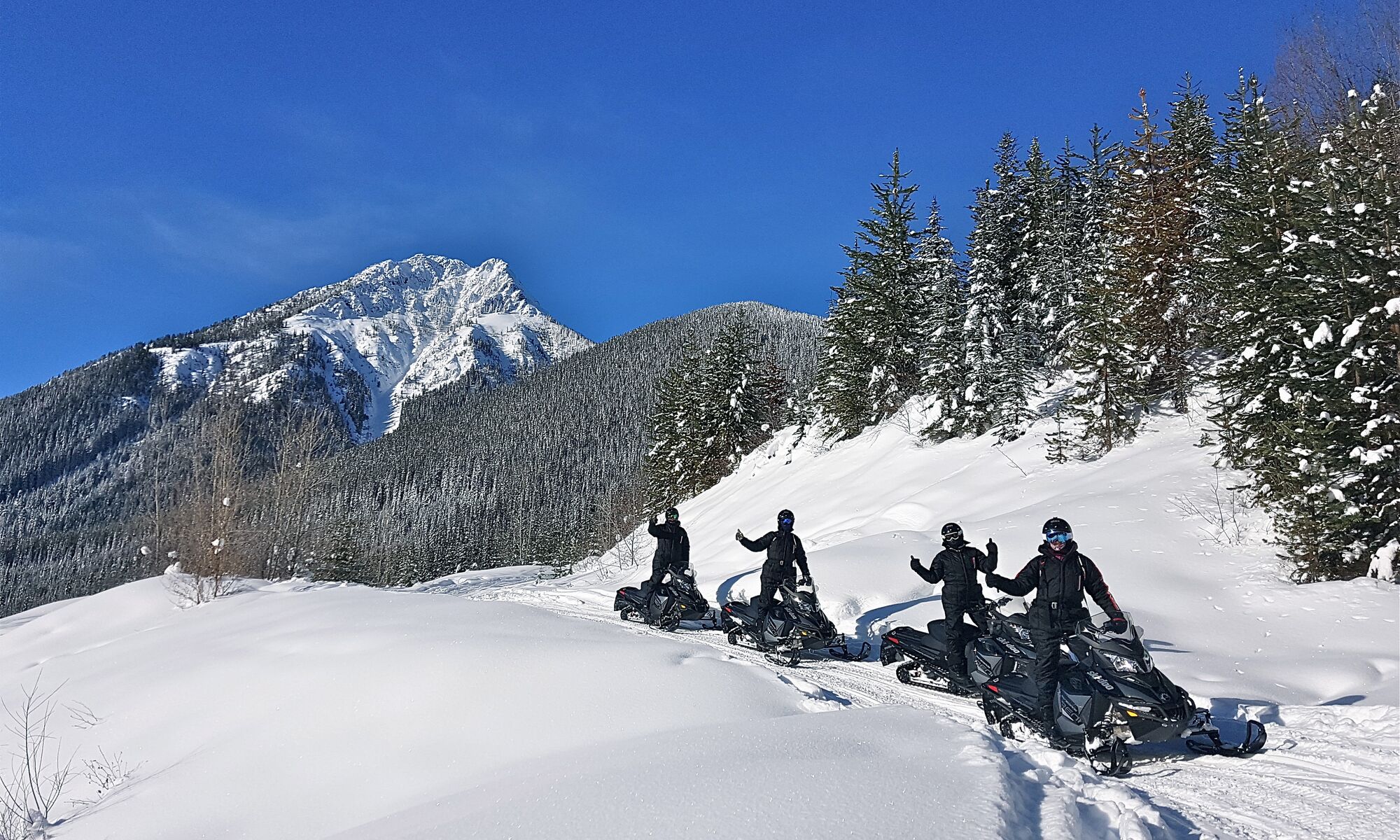 A group of people on a guided snowmobiling tour