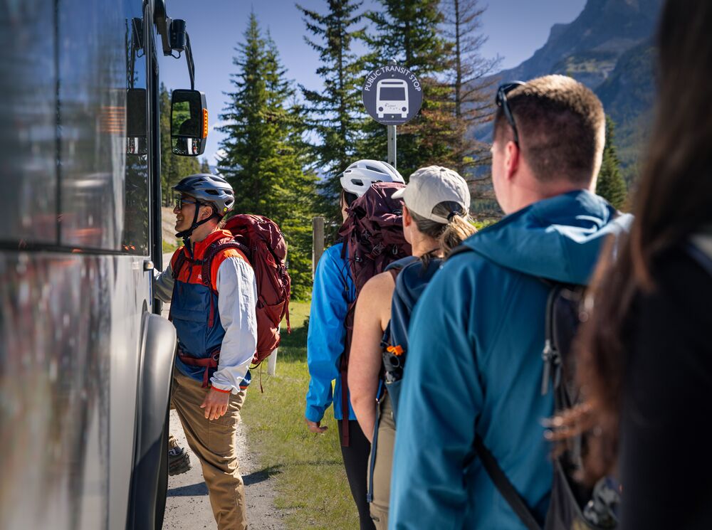A group of people getting on a Roam Transit bus in Banff National Park 