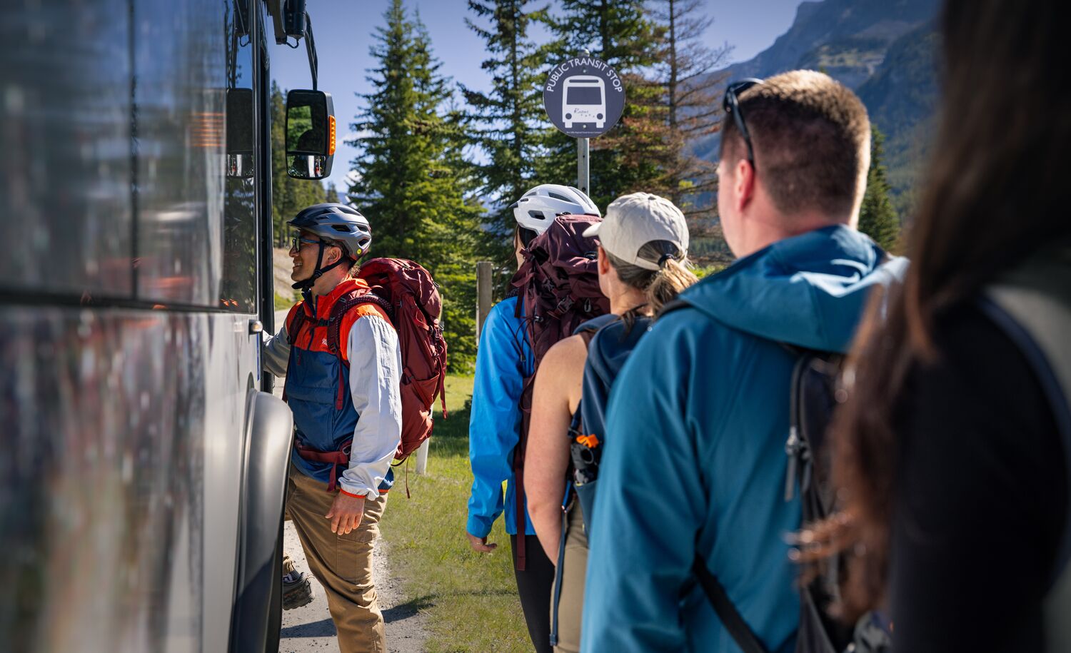 A group of people getting on a Roam Transit bus in Banff National Park 