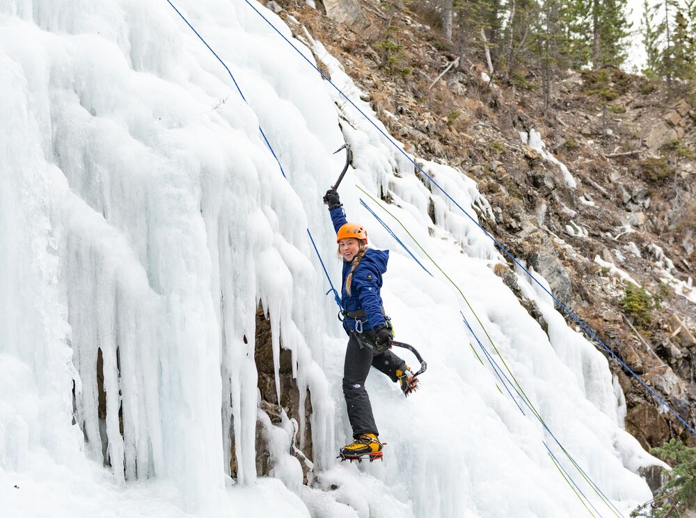 A women ice climbing on a waterfall in Banff National Park