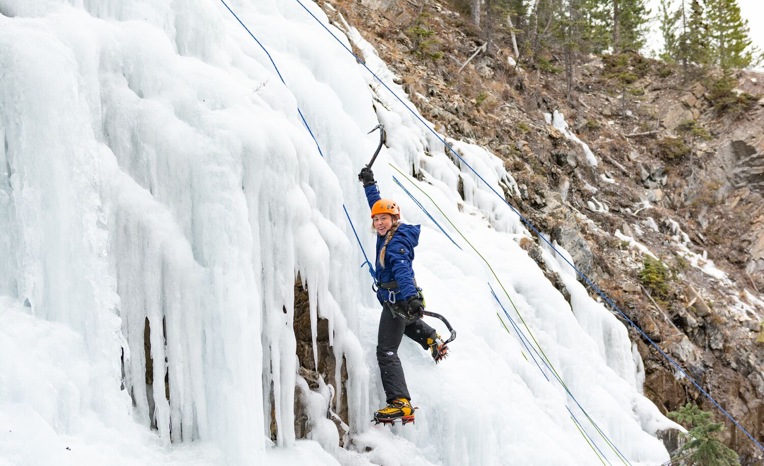 A women ice climbing on a waterfall in Banff National Park