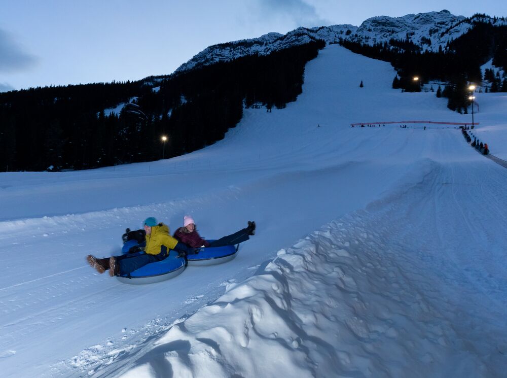 People tubing at night at Mount Norquay in Banff National Park