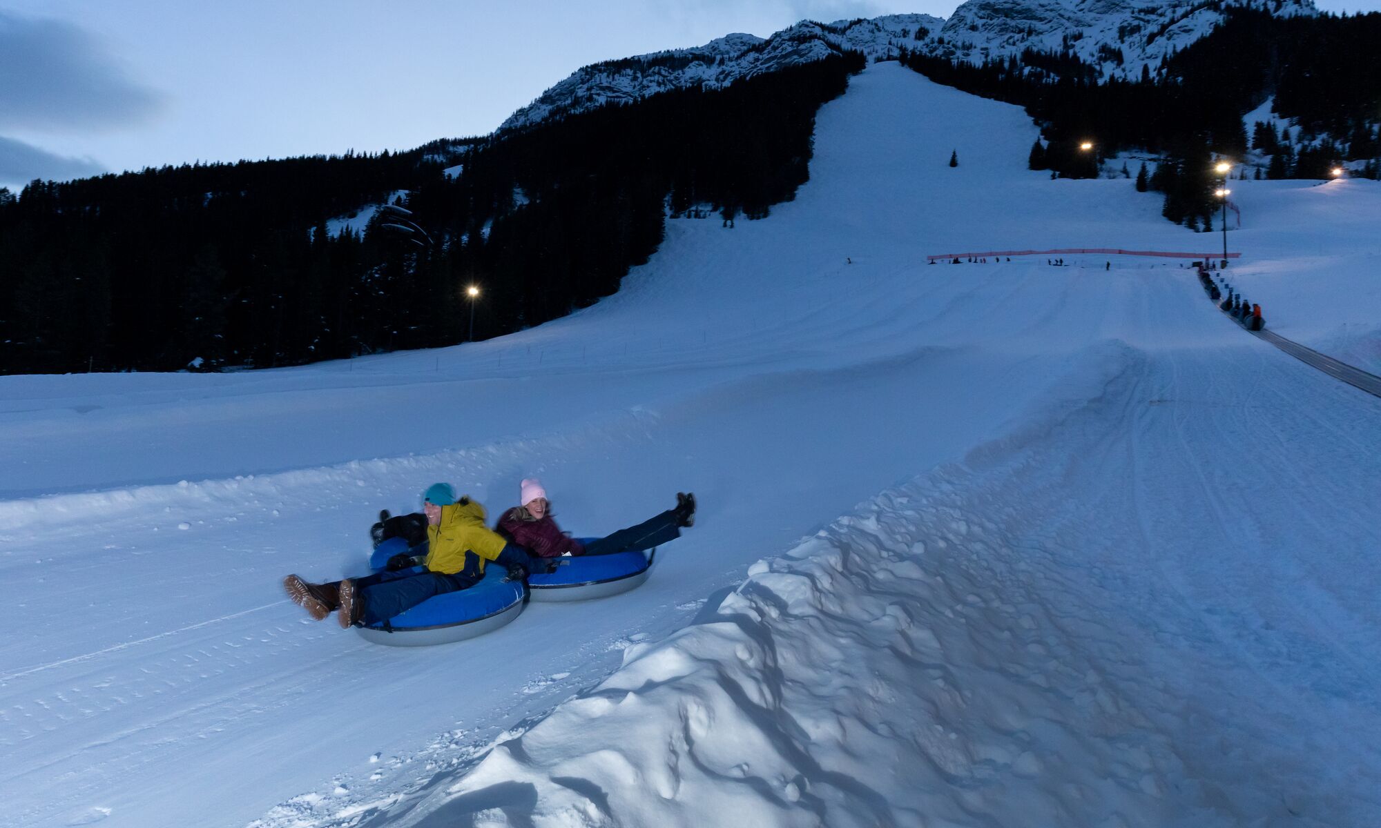 People tubing at night at Mount Norquay in Banff National Park