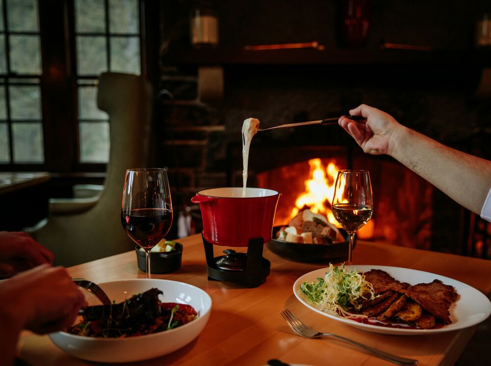 People eating fondue at the Waldhaus Pub at the Fairmont Banff Springs in Banff National Park