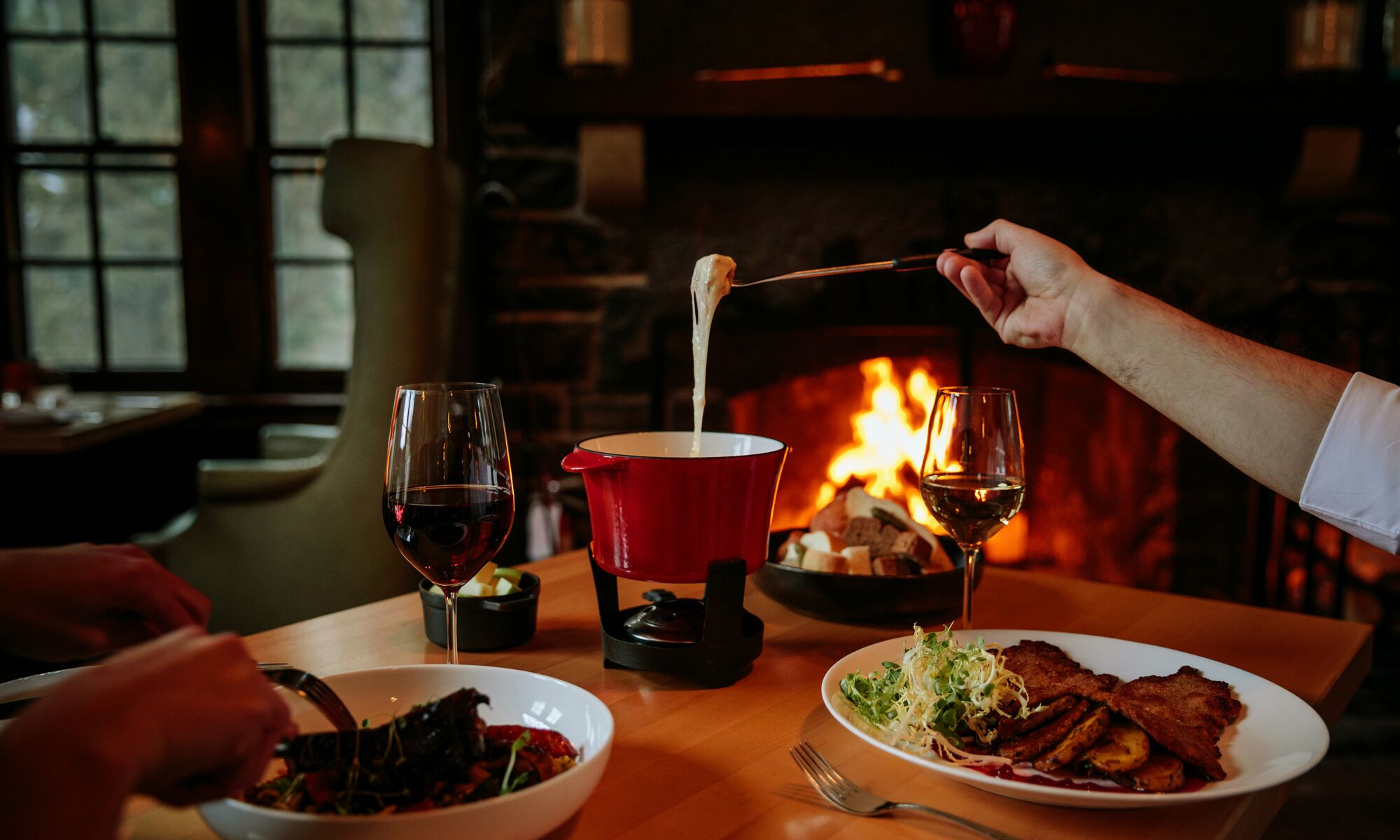 People eating fondue at the Waldhaus Pub at the Fairmont Banff Springs in Banff National Park