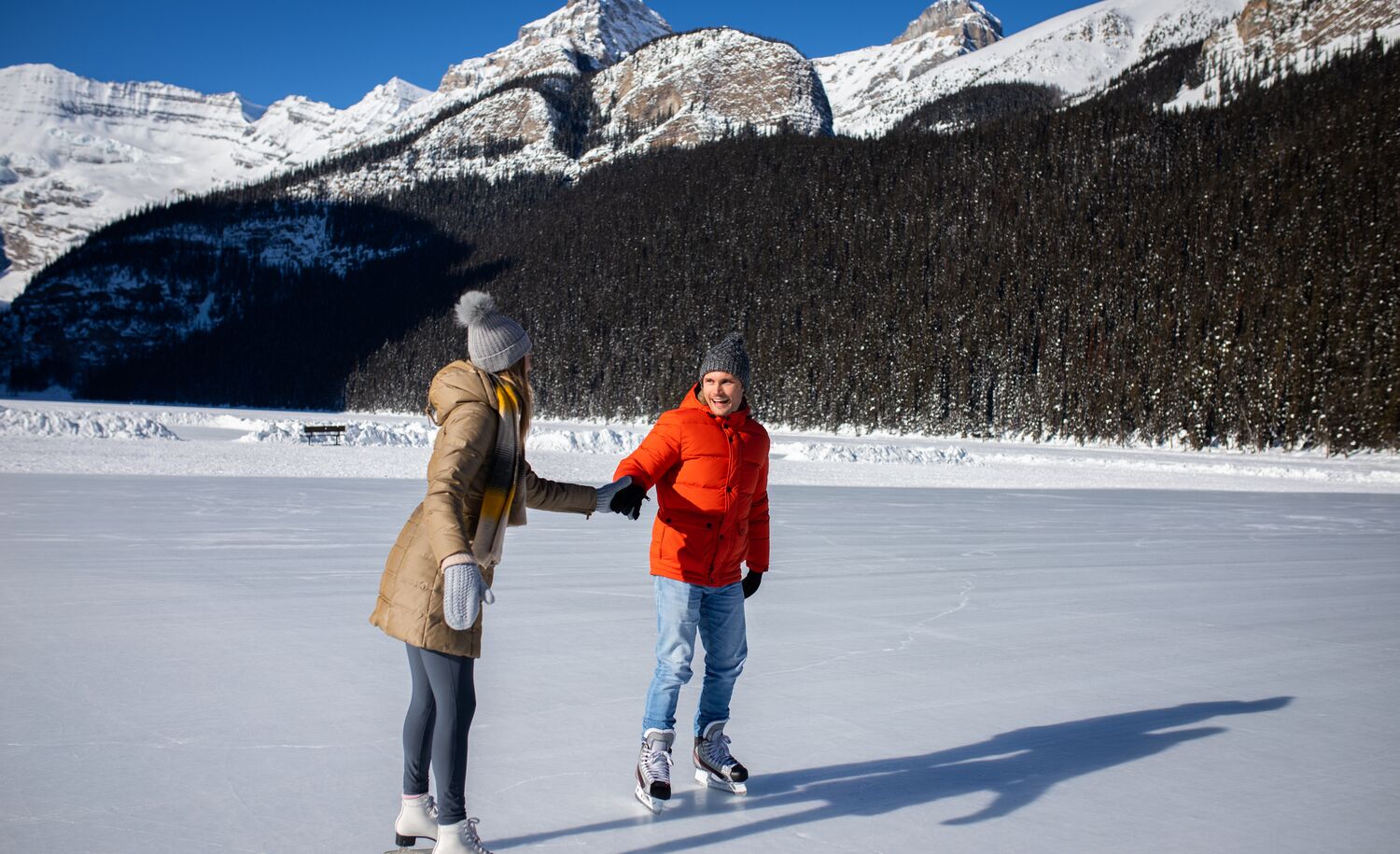 Two people ice skating on Lake Louise in Banff National Park