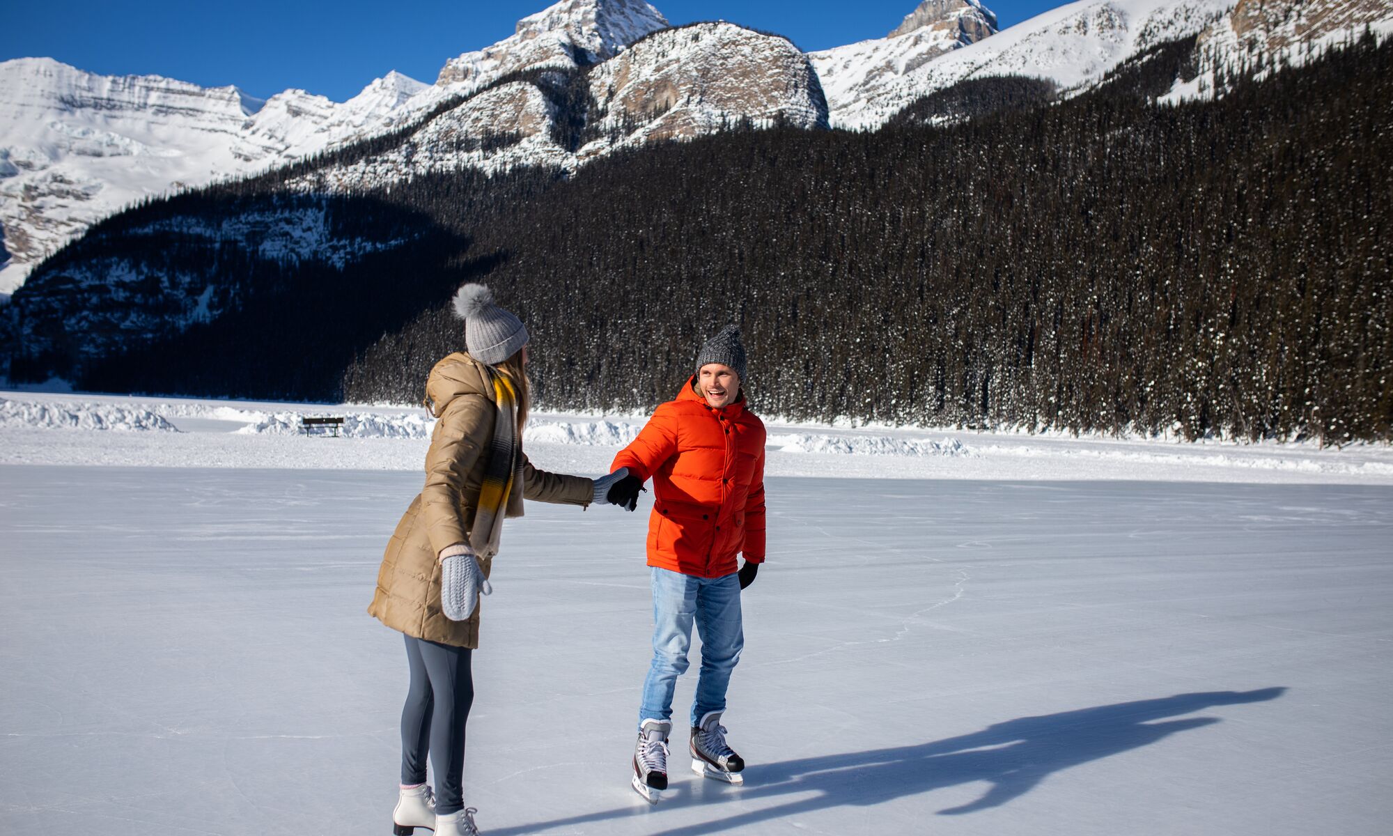 Two people ice skating on Lake Louise in Banff National Park