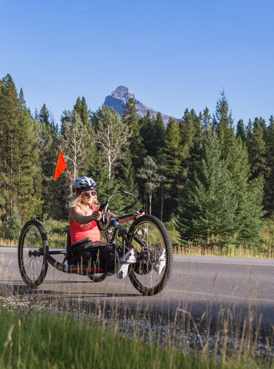 A cyclist bikes the Bow Valley Parkway in Banff National Park in the summer.
