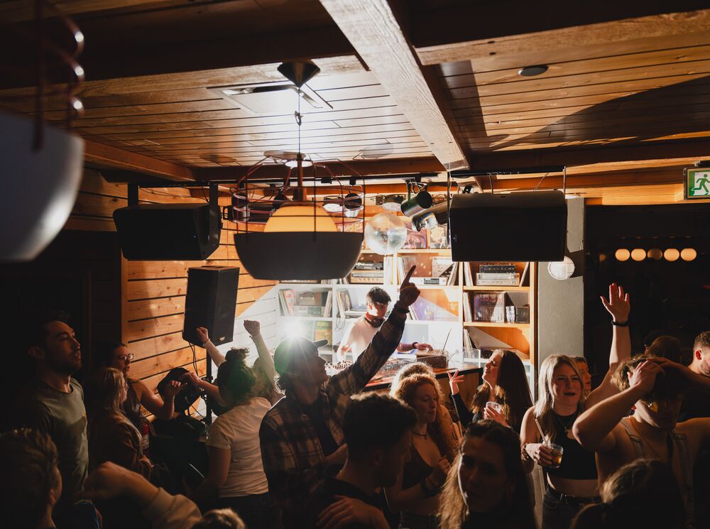 A group of people dancing at a bar in Banff National Park