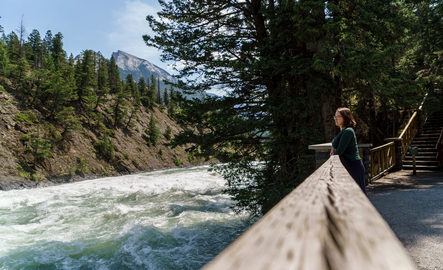 A women on the Bow River trail next to the Bow River in Banff National Park