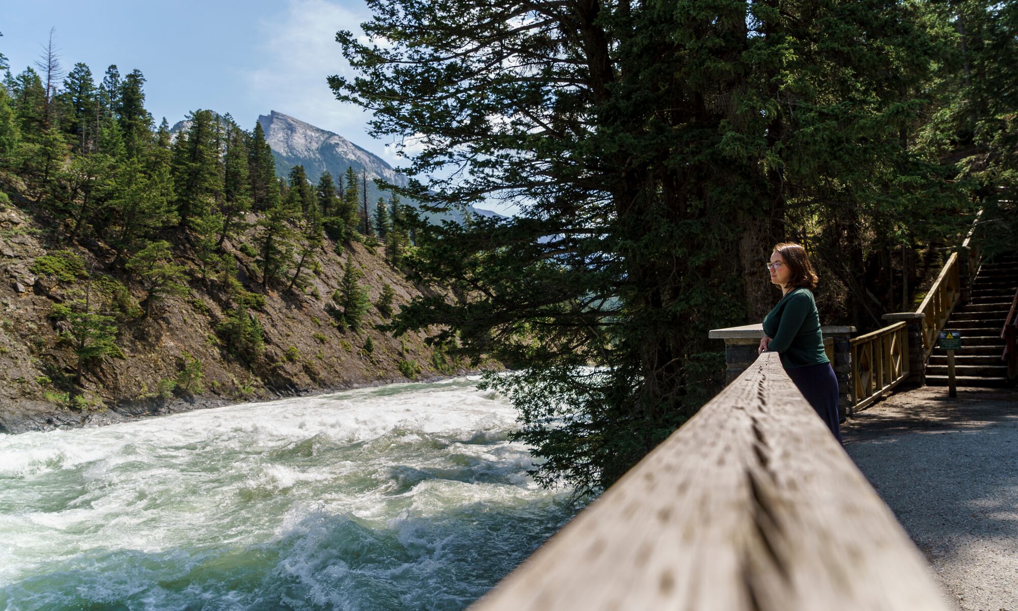 A women on the Bow River trail next to the Bow River in Banff National Park