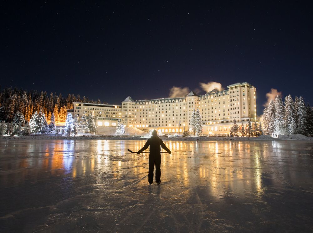 A person skating on Lake Louise at night in Banff National Park