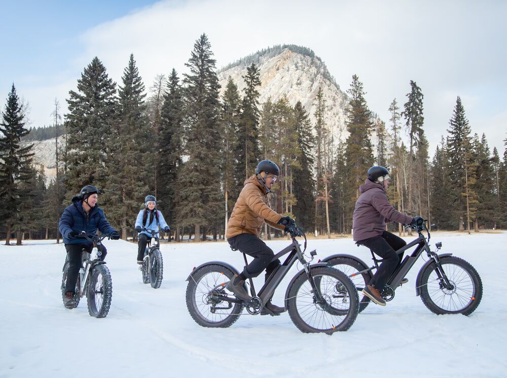 A group of people on a guided fat bike tour in winter in Banff National Park