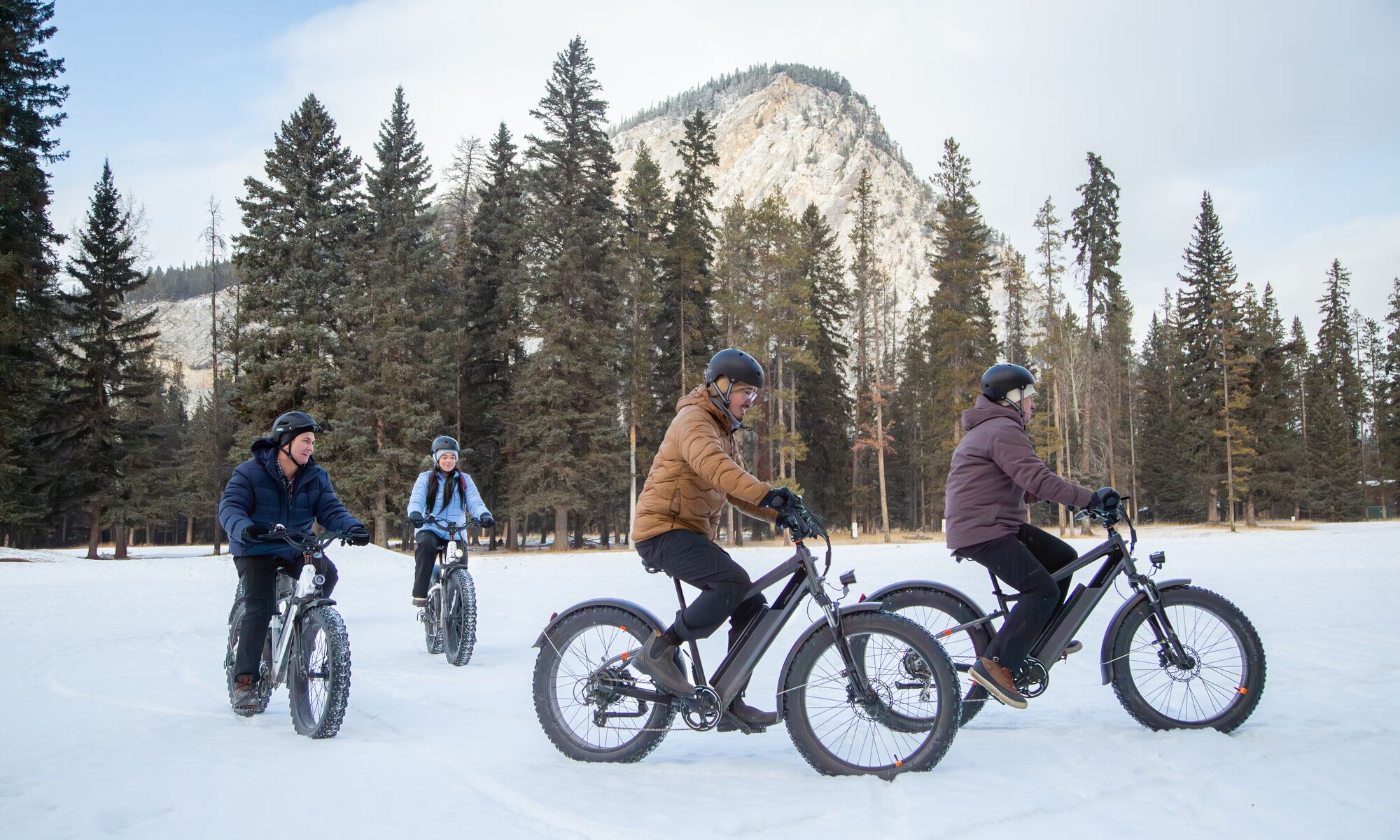 A group of people on a guided fat bike tour in winter in Banff National Park