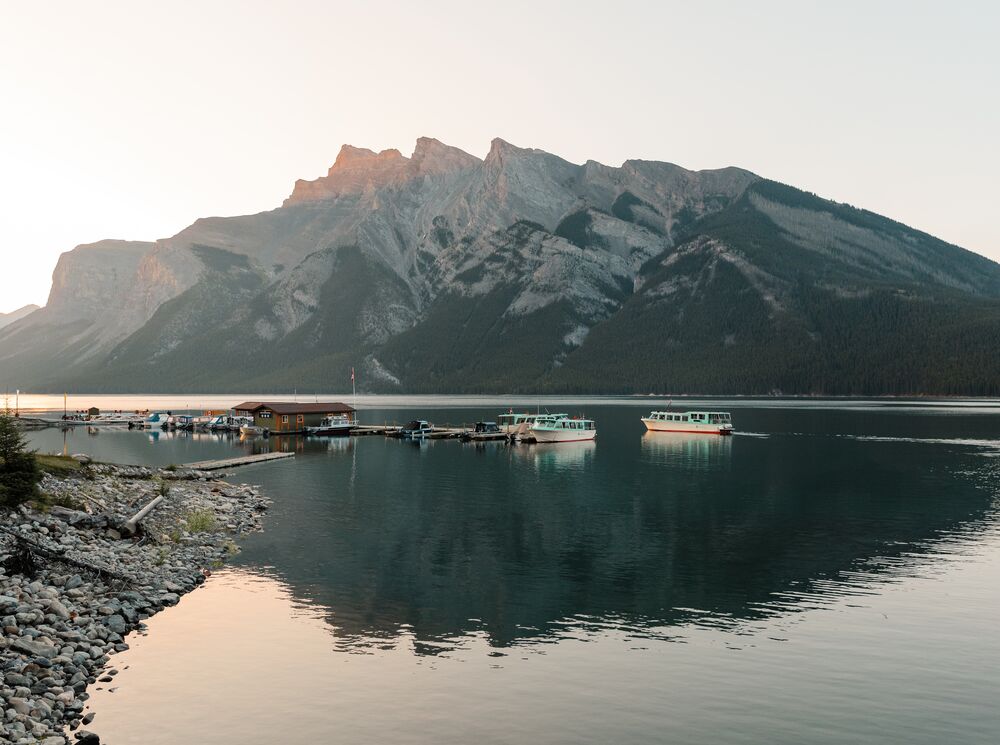 Lake Minnewanka and the Minnewanka boat dock at sunset in the summer.