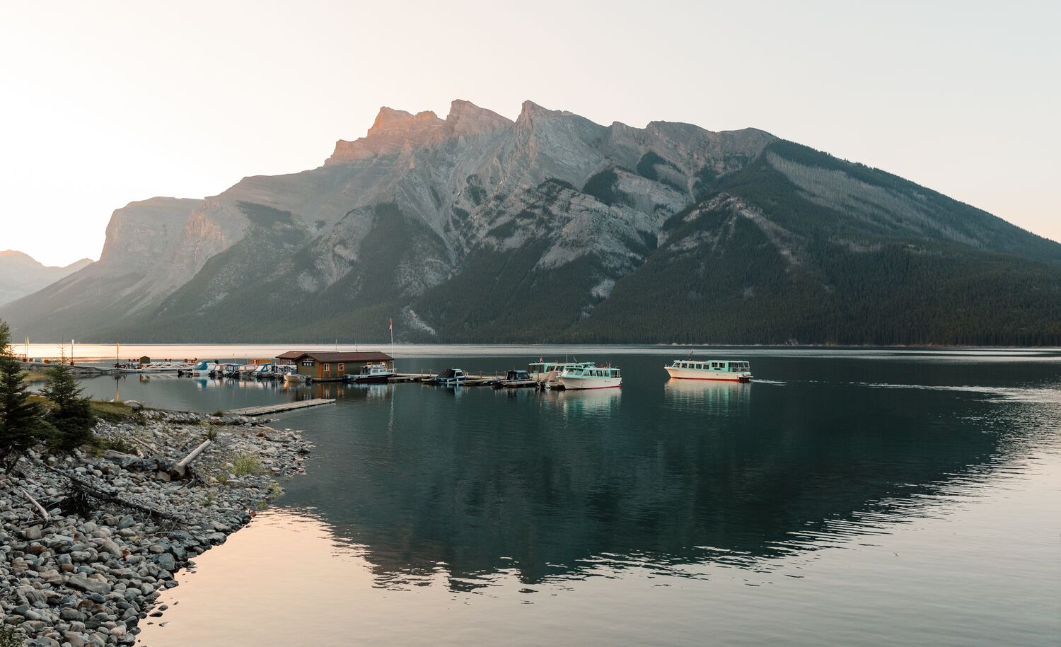 Lake Minnewanka and the Minnewanka boat dock at sunset in the summer.