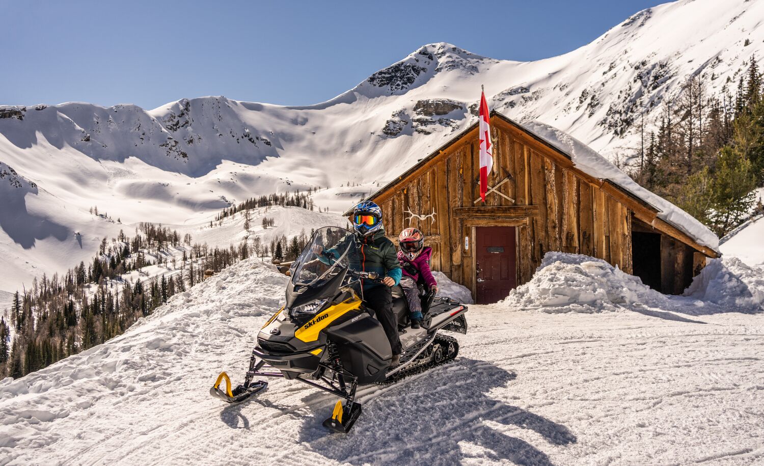 Two people on a snowmobile tour in the Canadian Rocky Mountains with Toby Creek Adventures