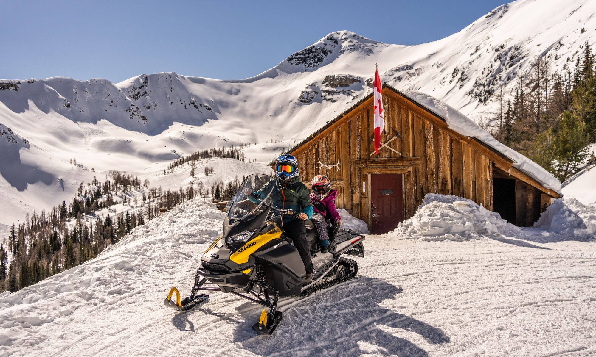 Two people on a snowmobile tour in the Canadian Rocky Mountains with Toby Creek Adventures