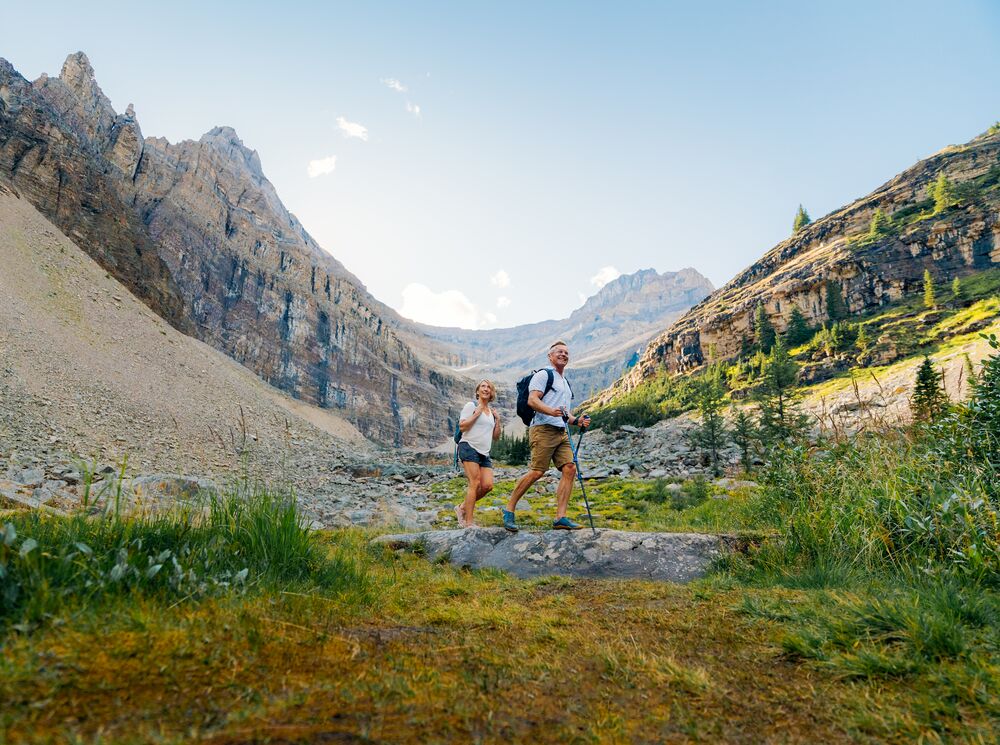 Two people walk near the switchbacks up Big Beehive, a hike in Lake Louise in Banff National Park.