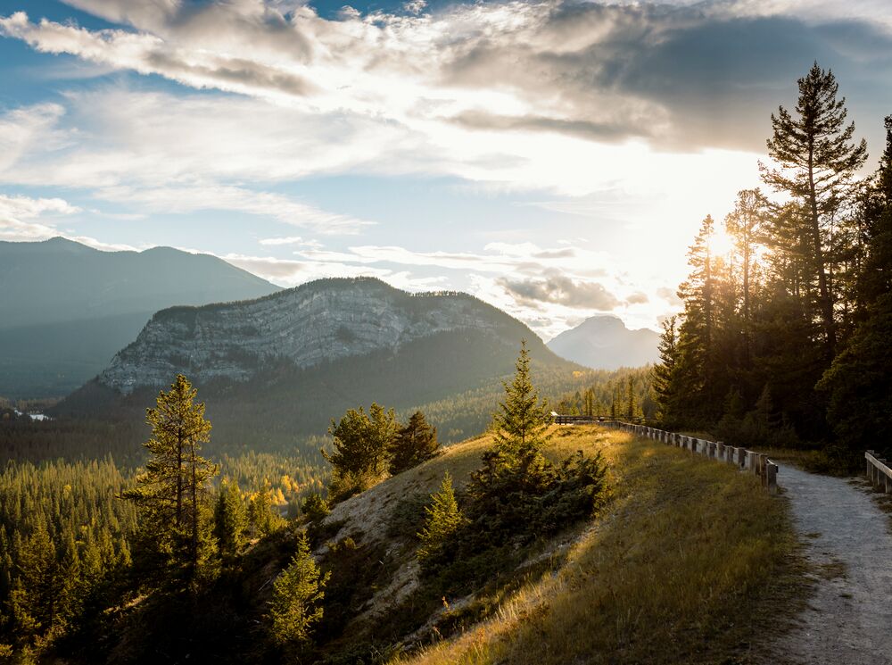 The Surprise Corner to Hoodoos Trail Tunnel Mountain is bathed in sunset light in the background.