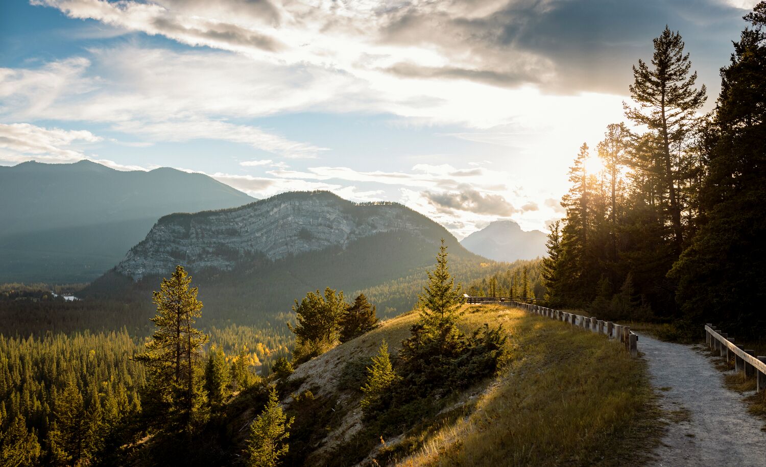 The Surprise Corner to Hoodoos Trail Tunnel Mountain is bathed in sunset light in the background.