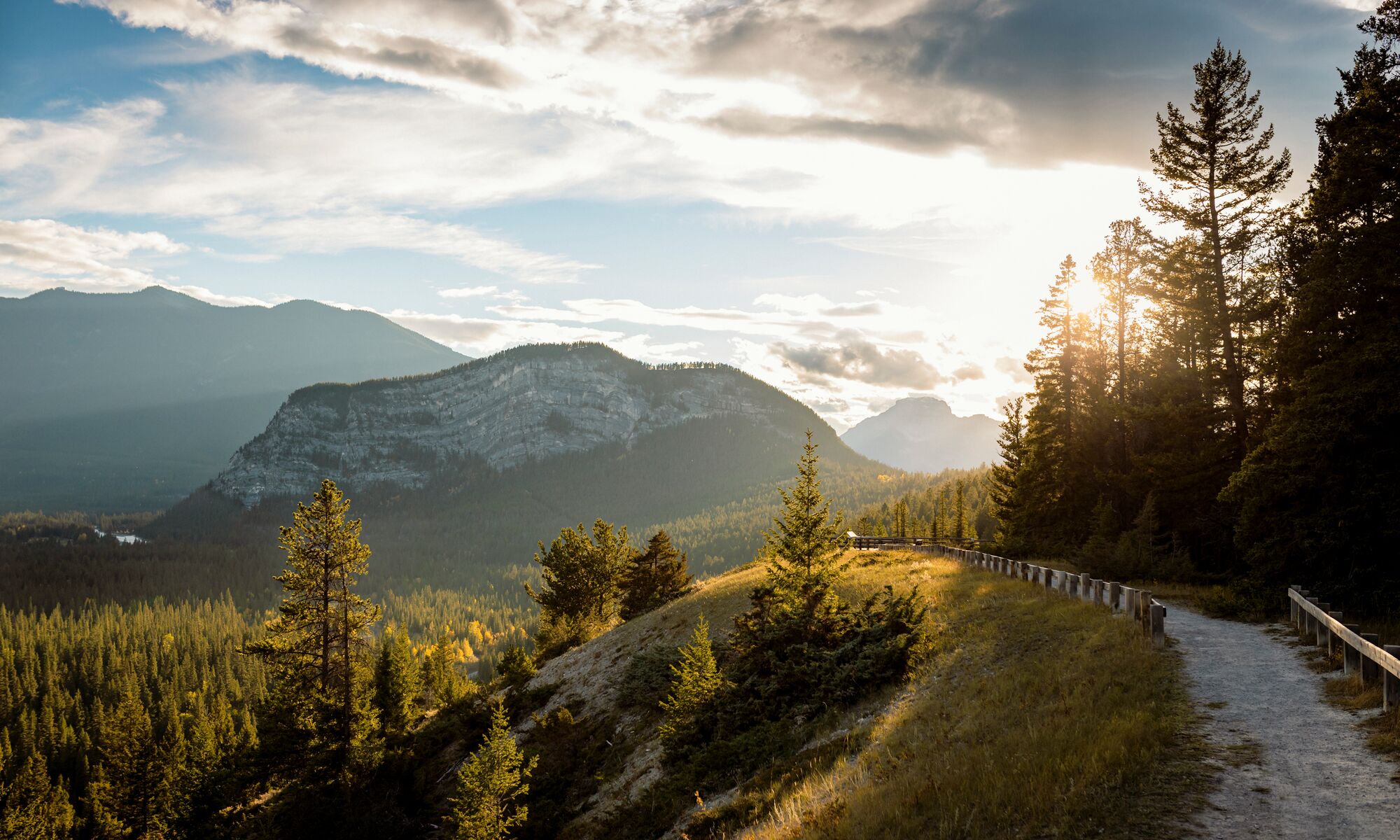 The Surprise Corner to Hoodoos Trail Tunnel Mountain is bathed in sunset light in the background.