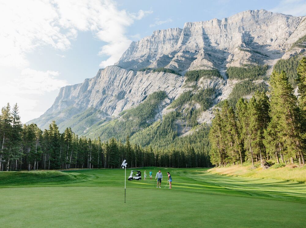 A group of people golfing at the Fairmont Banff Springs gold course in Banff National Park