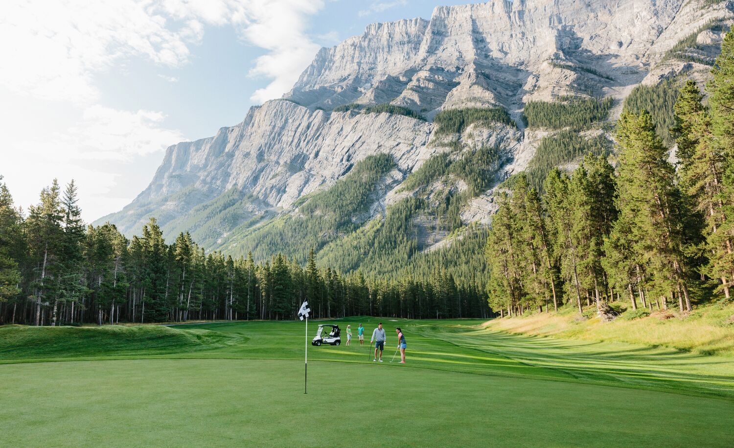 A group of people golfing at the Fairmont Banff Springs gold course in Banff National Park