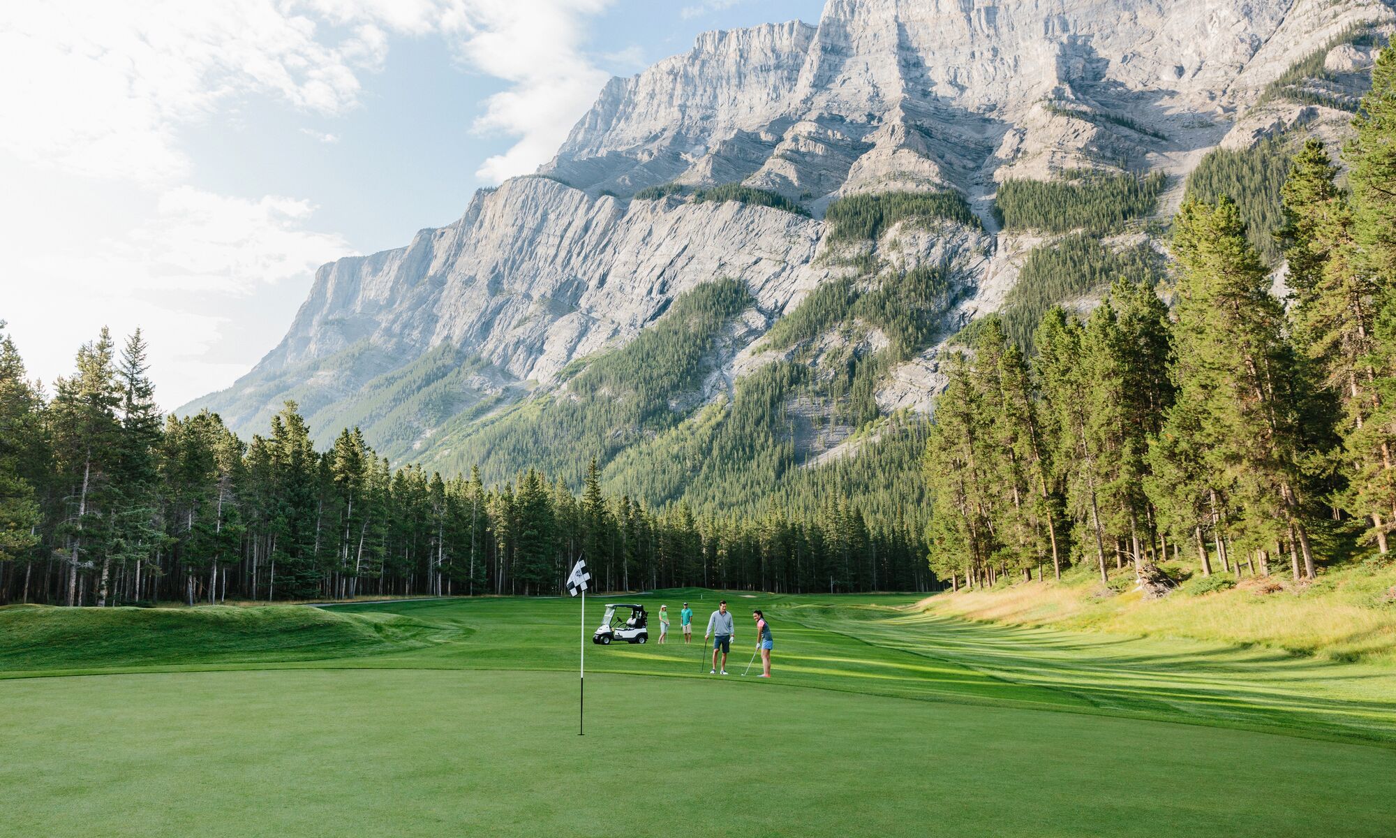 A group of people golfing at the Fairmont Banff Springs gold course in Banff National Park