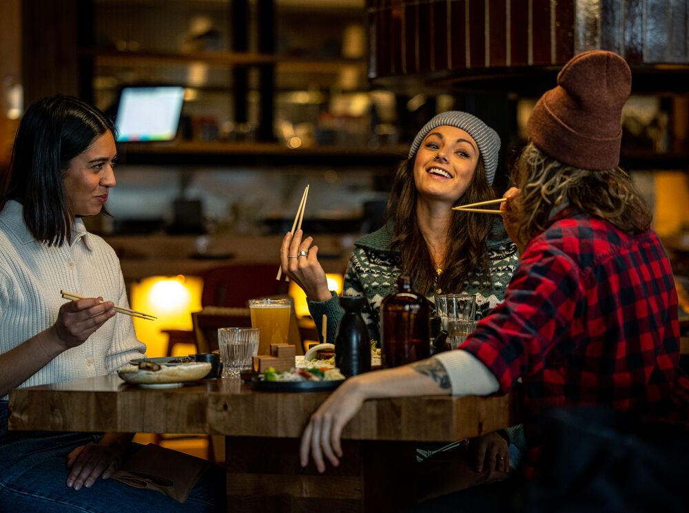 Three people eat at Hello Sunshine in Banff National Park.
