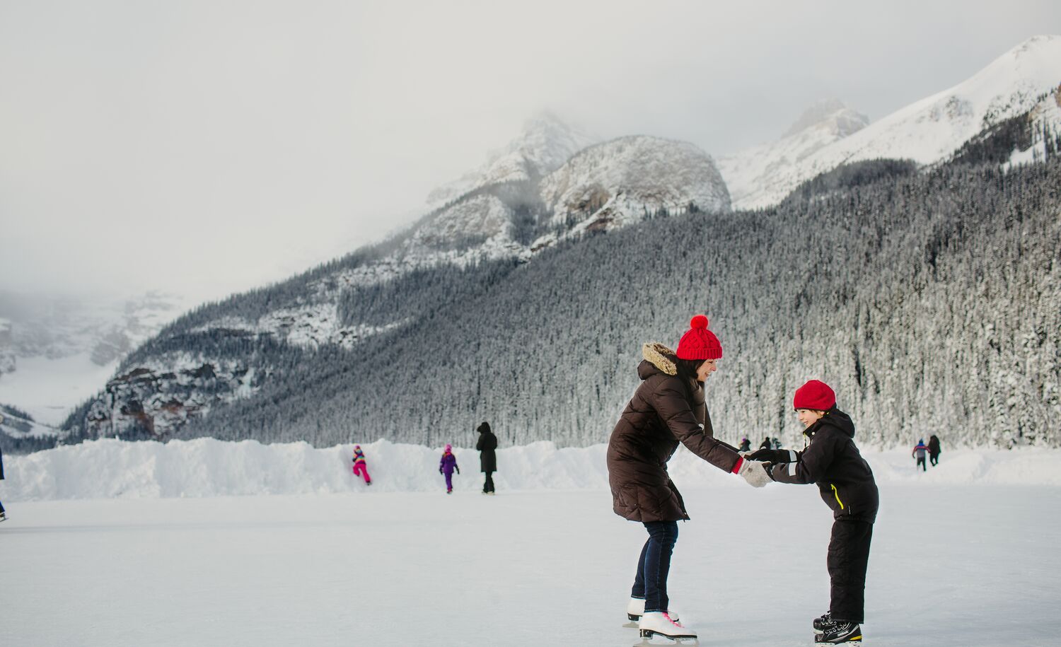 A family skating on Lake Louise in Banff National Park
